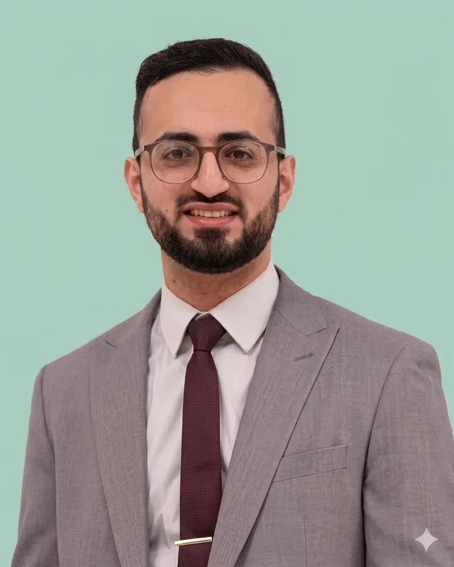 Sohail Shafiq, Superintendent Pharmacist at Belgrave PharmHealth, wearing a grey suit and glasses.